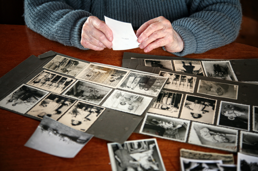 a photo of a woman looking at photographs.